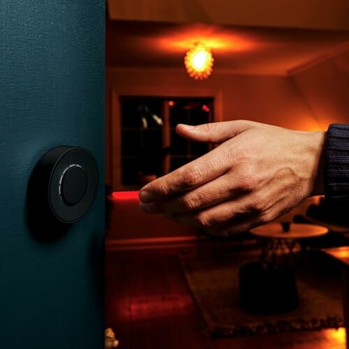 Hand reaching towards a smart doorbell with a cozy room in the background.